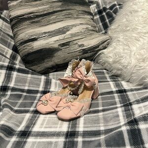 Pink heels with pearl accessories. They are a size 9. And they are from shein.